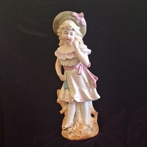 Elegant Porcelain Figurine with Pink Green and Gold Accents